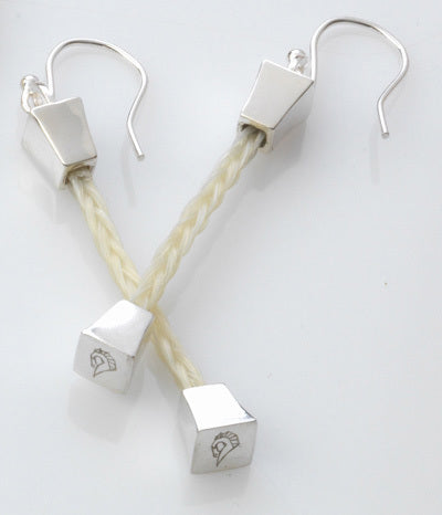 Forged Farriers Nail sterling silver drop earrings with cream square-braided horse hair and engraved horse-head end caps.