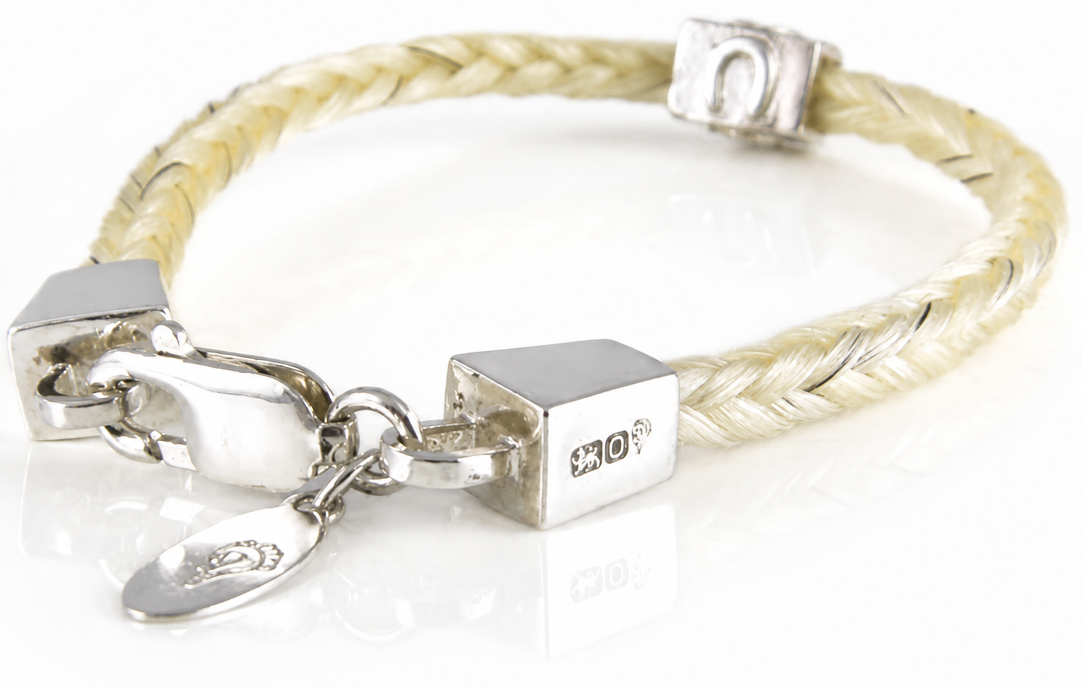 Forged Farriers Nail braided horse hair bracelet in cream and grey, handcrafted in sterling silver with a lobster clasp and engraved tag.
