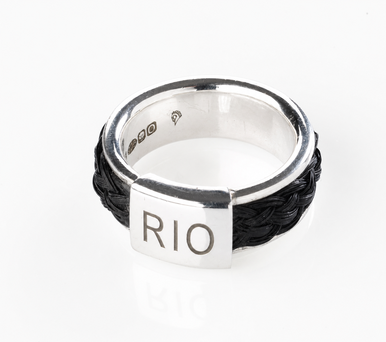 Quintessentially Equine Bold Braided Ring in sterling silver with black horse hair and engraved name plate reading “RIO”.