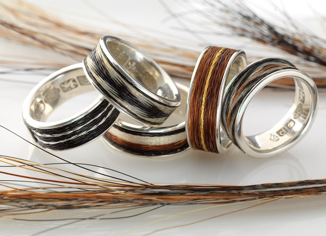 Five Woven Stories Ribbon Rings in sterling silver with handwoven black, white and chestnut horse hair, including gold-thread brocade details.