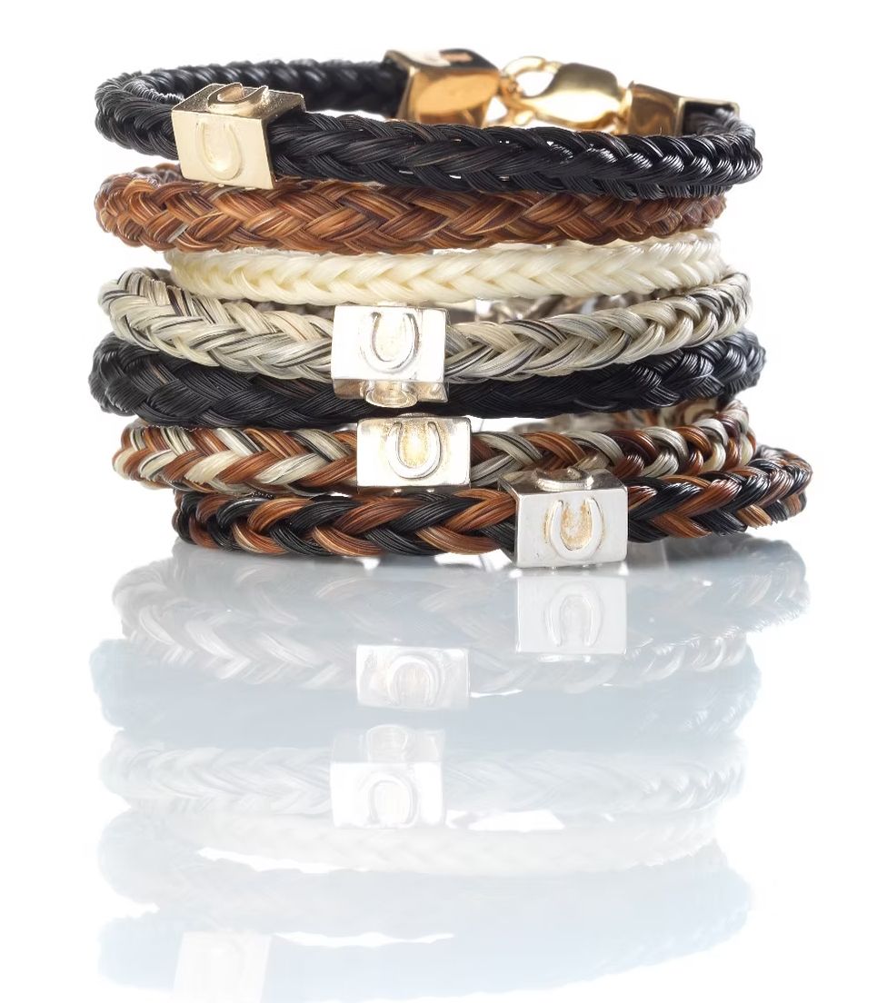 Stack of round and square handbraided horse hair bracelets in black, chestnut, grey and mixed colours, finished with silver and gold fittings.