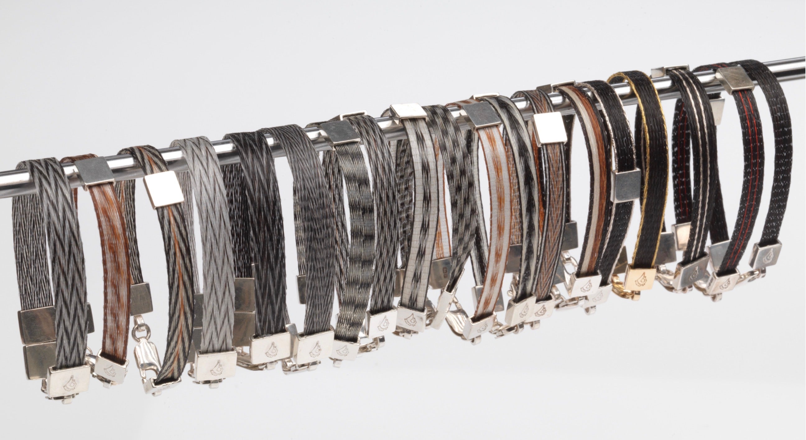 Woven Stories Ribbon Bracelets in varied handwoven horse hair patterns and colourways with sterling silver and gold fittings.