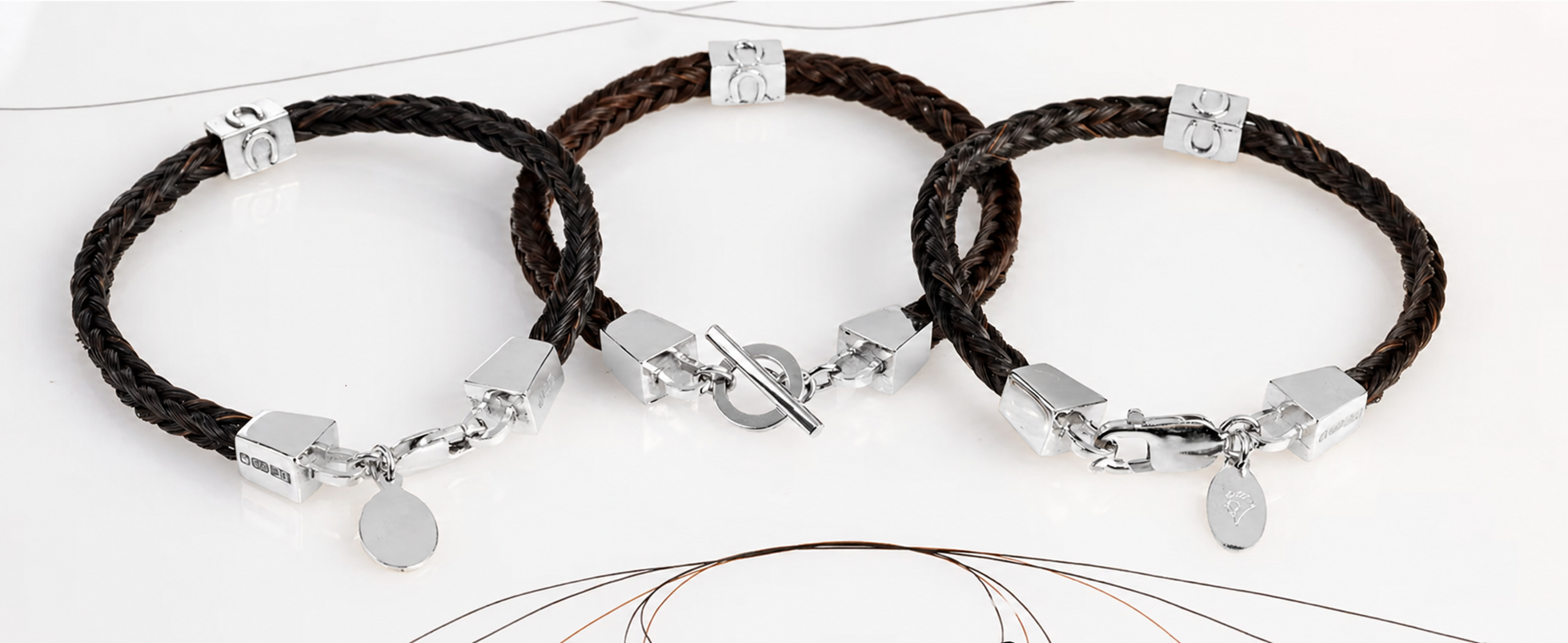 Three dark brown and black square-braided horse hair bracelets from the Forged Farriers Nail range, with sterling silver lobster and toggle clasps.