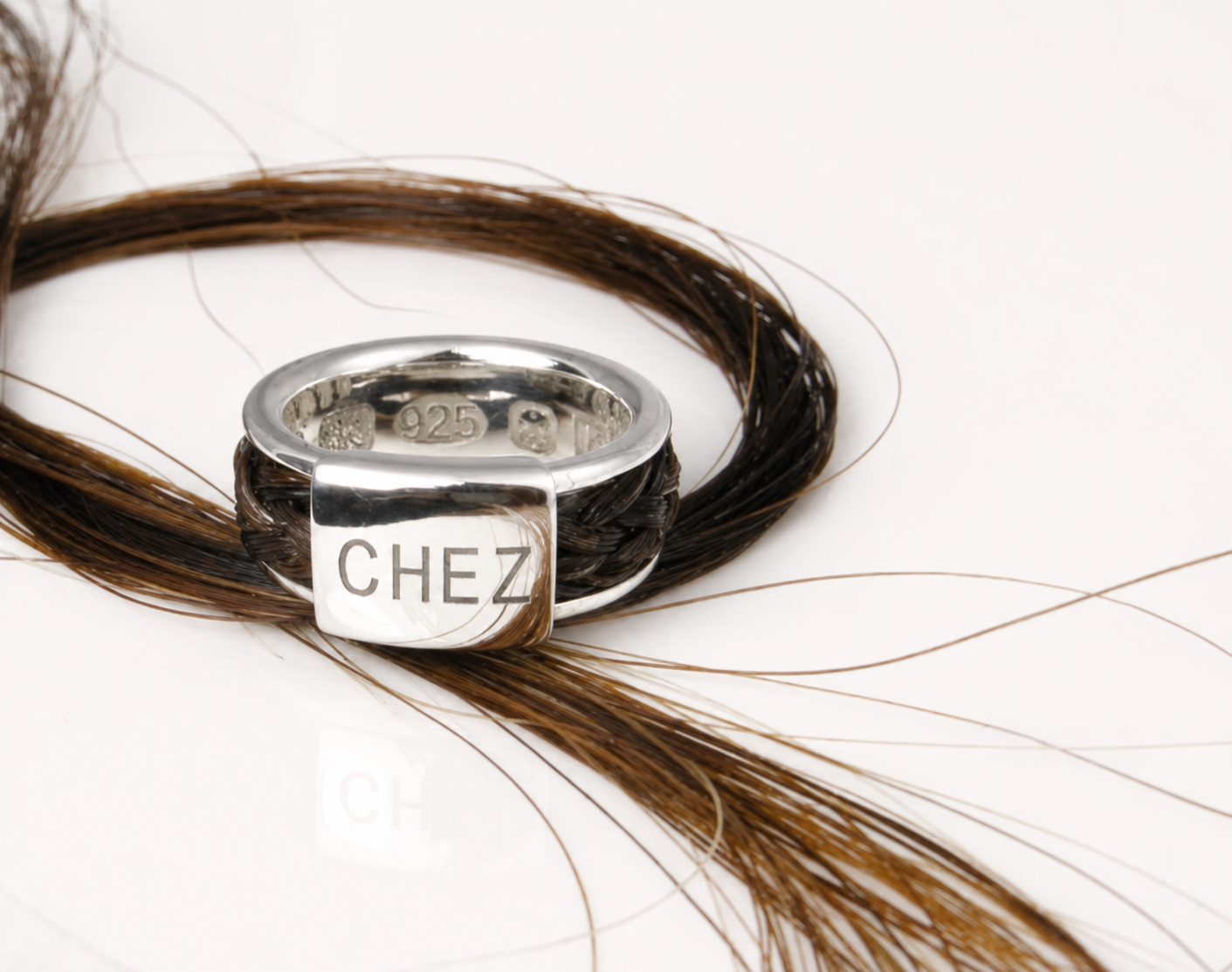 Quintessentially Equine Bold Braided Ring in sterling silver with chestnut horse hair and engraved name plate reading “CHEZ”.